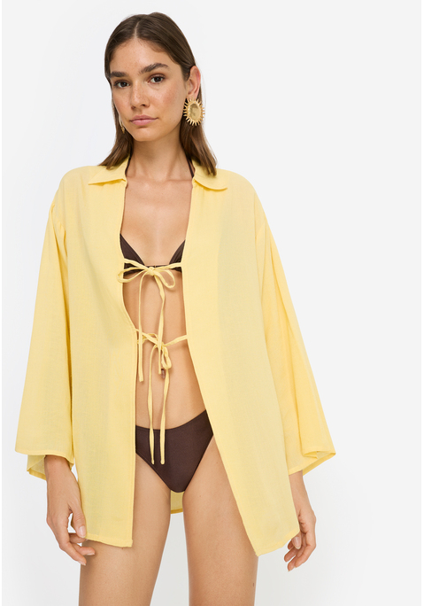 Bild: Tunika von LSCN by LASCANA: Lässige Strand-Tunika von LSCN by Lascana mit langen Ärmeln und Blusenkragen. Vorne offen und mit je zwei Bändern zum Binden versehen. Gerader Saum vorne, hinten abgerundet und tiefer fallend. Trageangenehme Qualität mit Viskose.